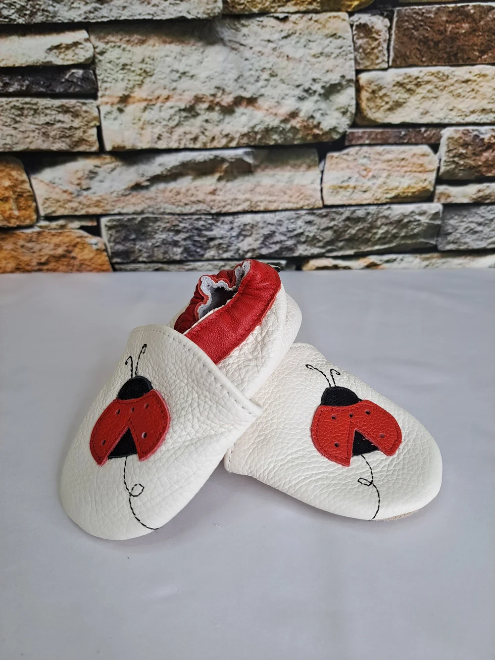 Baby White Leather Slip-On Shoes with Red Ladybug Detail
